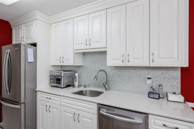 kitchen featuring appliances with stainless steel finishes, a sink, and white cabinets