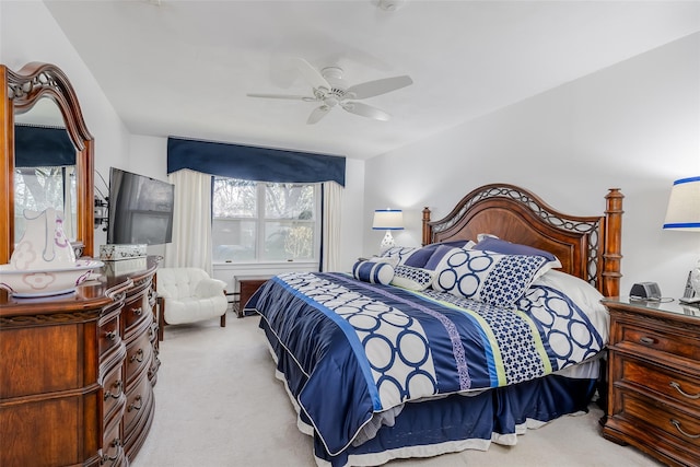 bedroom featuring light colored carpet and ceiling fan