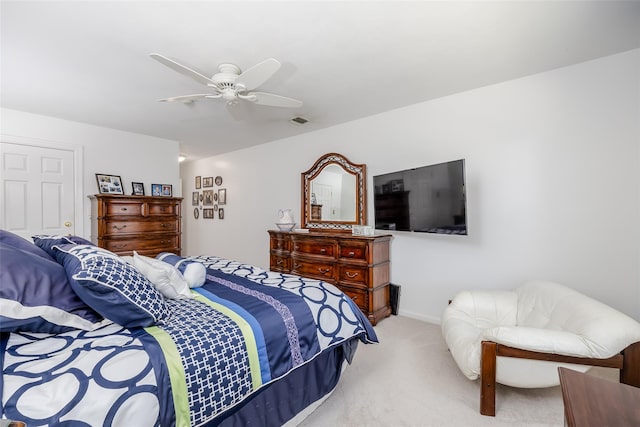 bedroom featuring light carpet, ceiling fan, visible vents, and baseboards