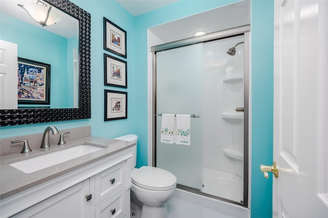 bathroom featuring a stall shower, vanity, and toilet