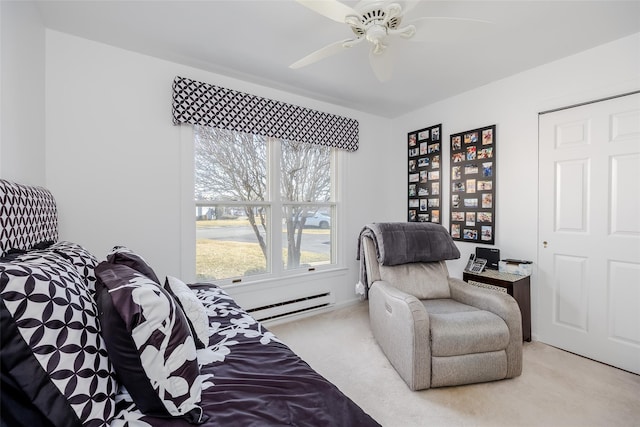 sitting room featuring ceiling fan, baseboard heating, and light colored carpet