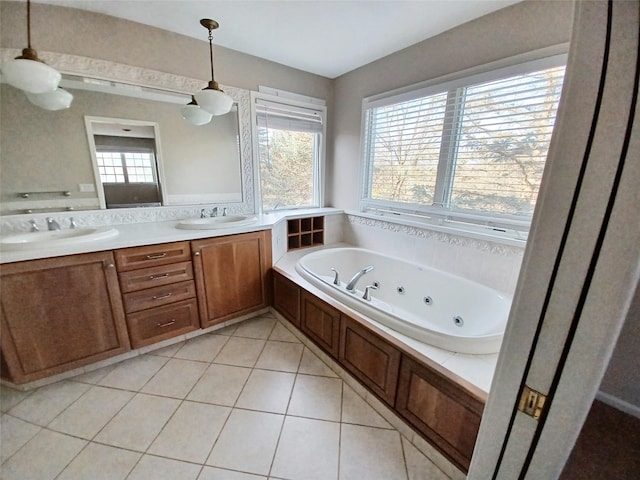 full bath with double vanity, a tub with jets, tile patterned flooring, and a sink