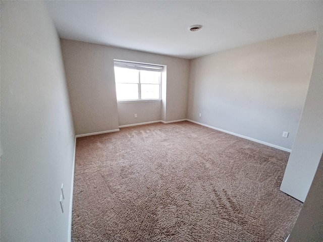 carpeted spare room with baseboards