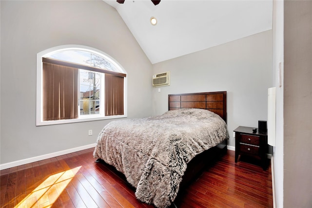 bedroom featuring dark wood-style flooring, ceiling fan, baseboards, and a wall mounted AC