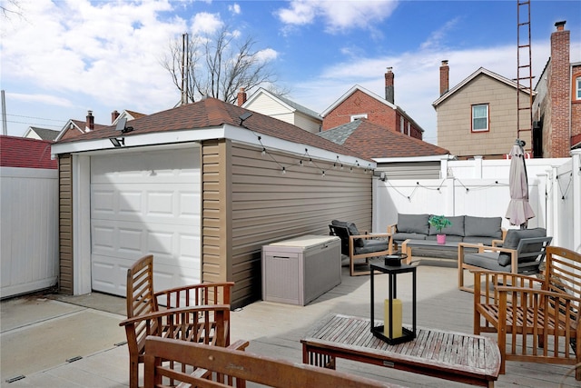 view of patio / terrace with a garage, fence, an outdoor living space, and a wooden deck