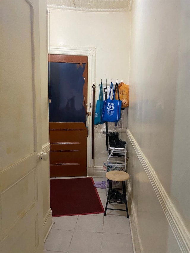 doorway to outside with light tile patterned floors