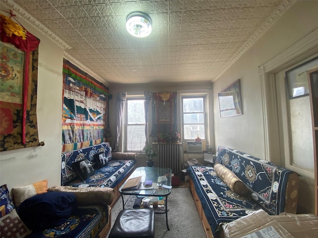 living area with an ornate ceiling, carpet, and crown molding