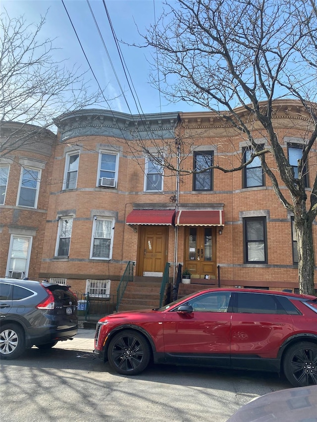 townhome / multi-family property featuring brick siding