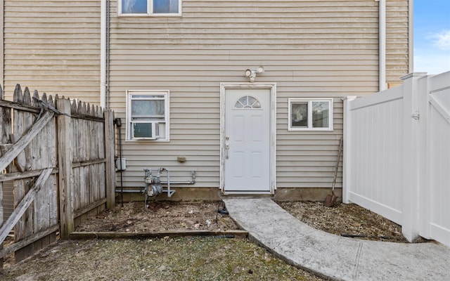 view of exterior entry featuring fence