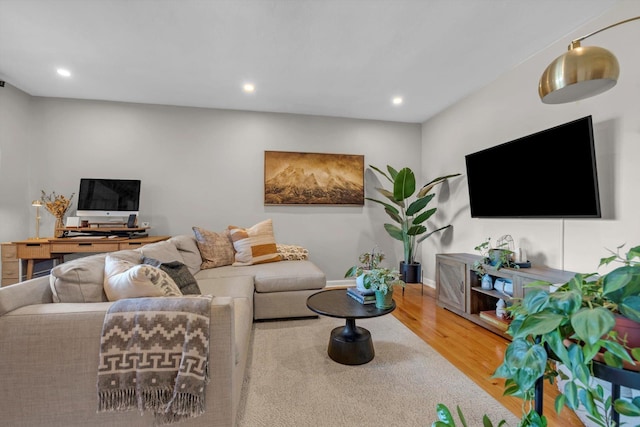 living room with baseboards, wood finished floors, and recessed lighting