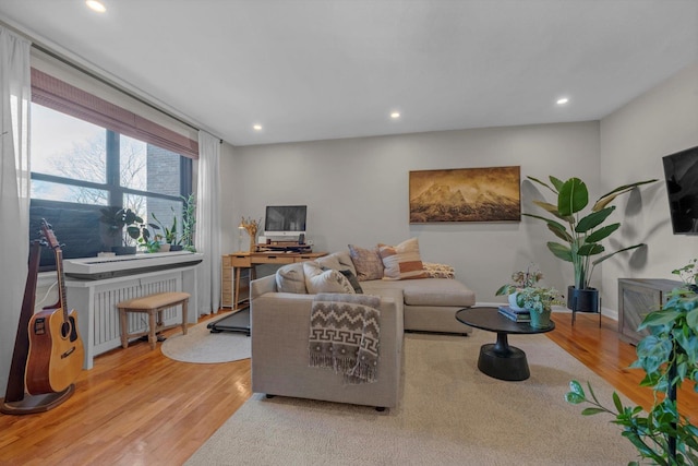 living area featuring recessed lighting, radiator heating unit, and wood finished floors