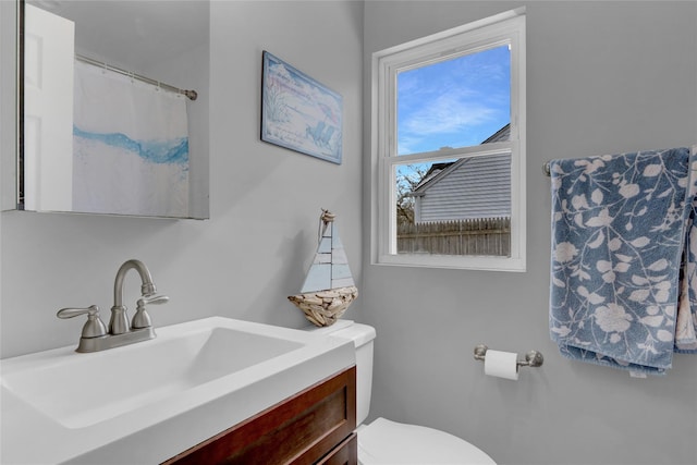 full bathroom featuring toilet and vanity