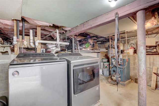 washroom featuring washer and dryer, laundry area, and a heating unit