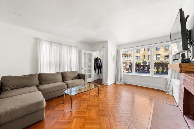 living room featuring a fireplace and baseboards