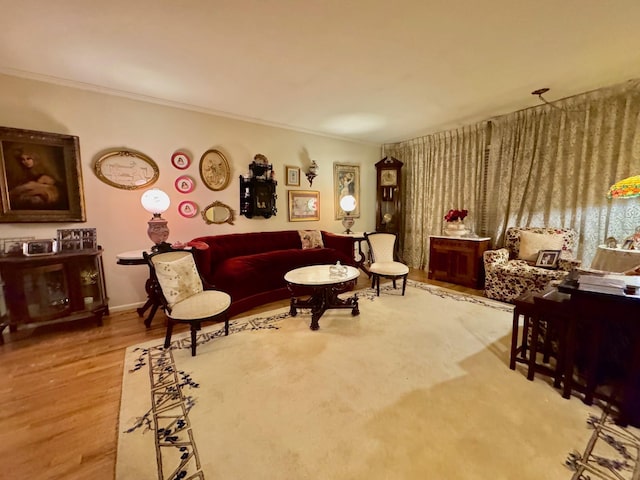 living area with baseboards, crown molding, and wood finished floors