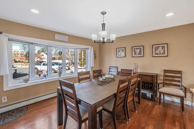 dining room with dark wood-style floors, recessed lighting, baseboard heating, a chandelier, and baseboards