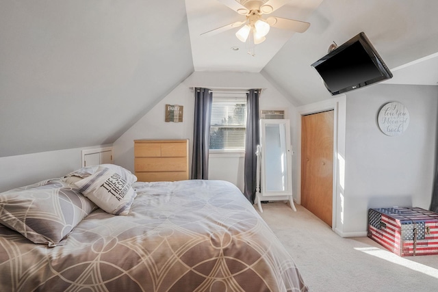 bedroom featuring lofted ceiling, a ceiling fan, and light colored carpet