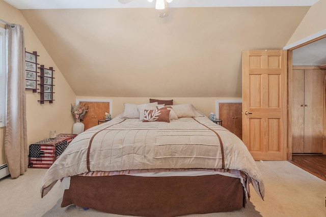 carpeted bedroom featuring lofted ceiling