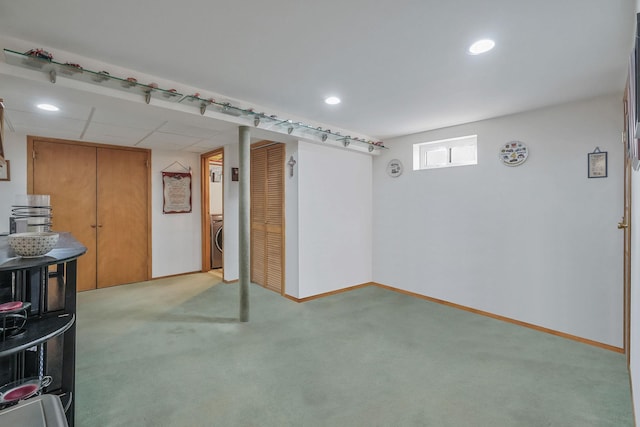 basement with recessed lighting, washer / clothes dryer, light carpet, and baseboards