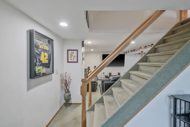 stairs with baseboards and recessed lighting