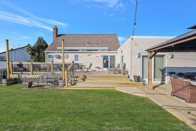 rear view of house featuring a yard, a shingled roof, and a wooden deck