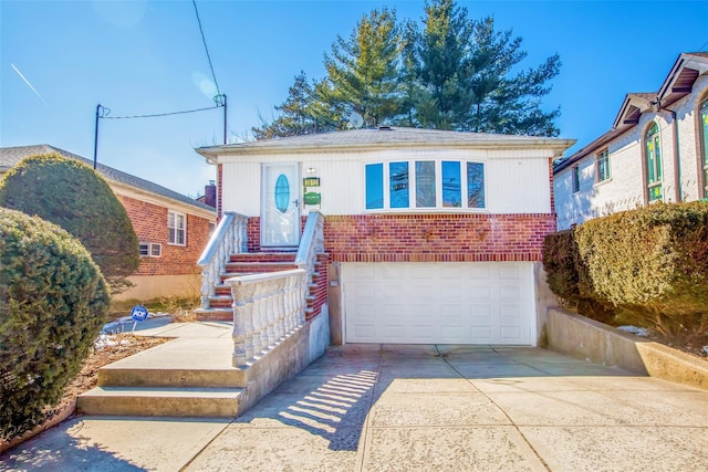 view of front of property with a garage, concrete driveway, and brick siding