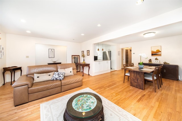 living room with light wood-type flooring and recessed lighting