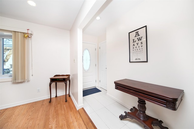 entrance foyer with a healthy amount of sunlight, light wood-style flooring, baseboards, and recessed lighting