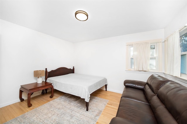 bedroom featuring wood finished floors and baseboards