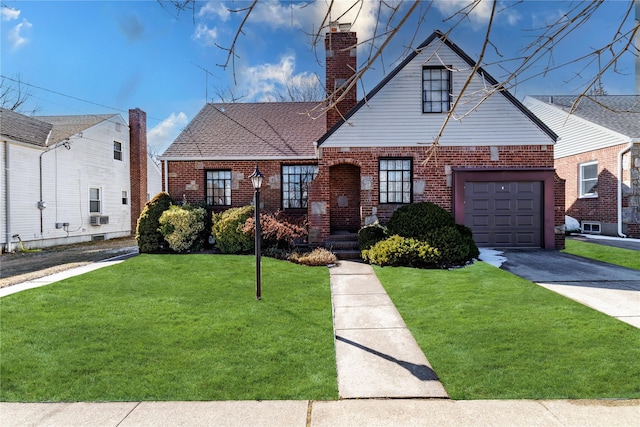 view of front of home featuring brick siding, a chimney, a garage, driveway, and a front lawn