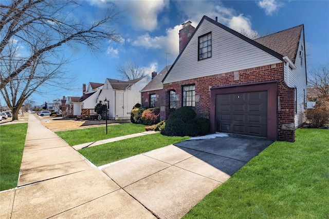 view of front of home featuring a front yard, a chimney, concrete driveway, and brick siding