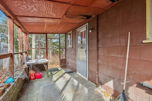 unfurnished sunroom with wooden ceiling