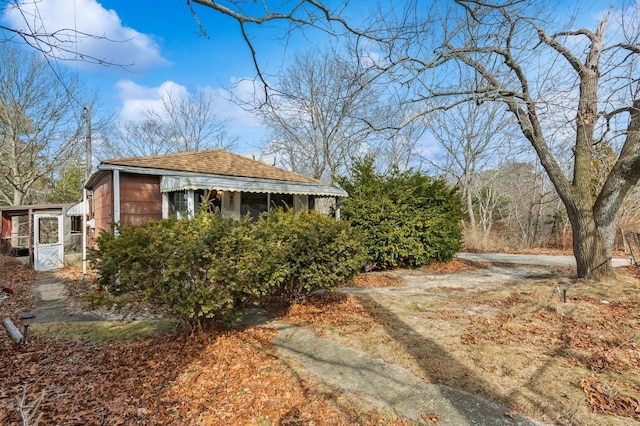 view of side of property with a shingled roof