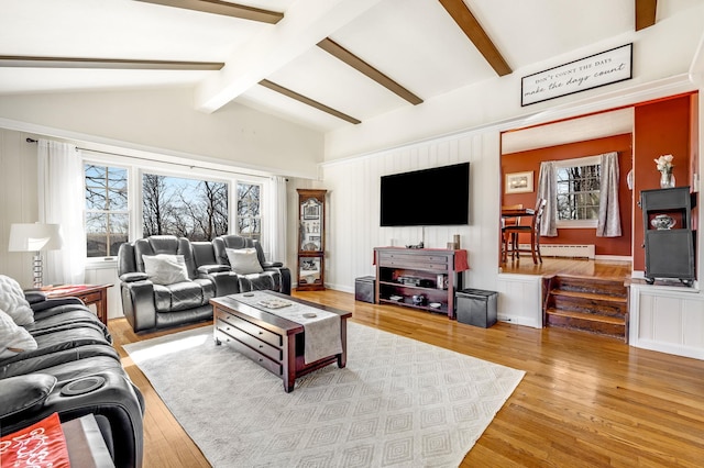 living room with vaulted ceiling with beams, baseboard heating, and wood finished floors