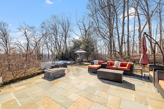 view of patio / terrace featuring an outdoor living space with a fire pit and a pool