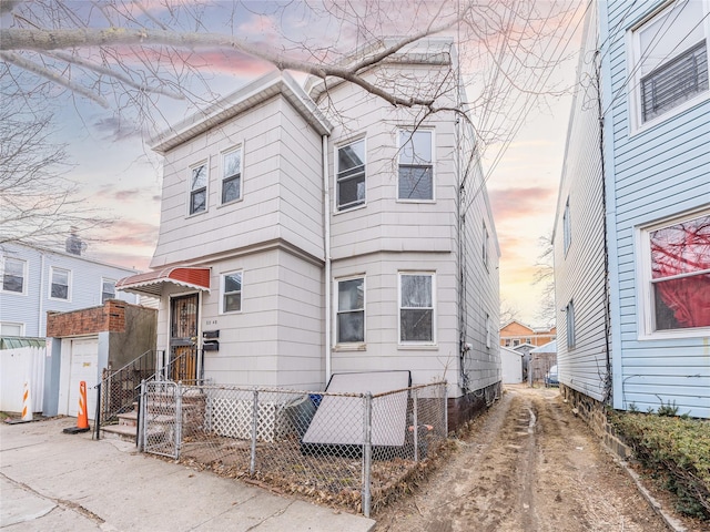 rear view of property featuring fence