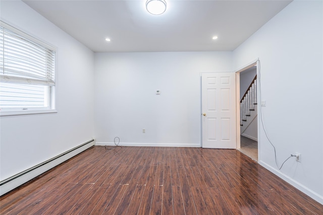 empty room with baseboards, dark wood finished floors, stairway, baseboard heating, and recessed lighting