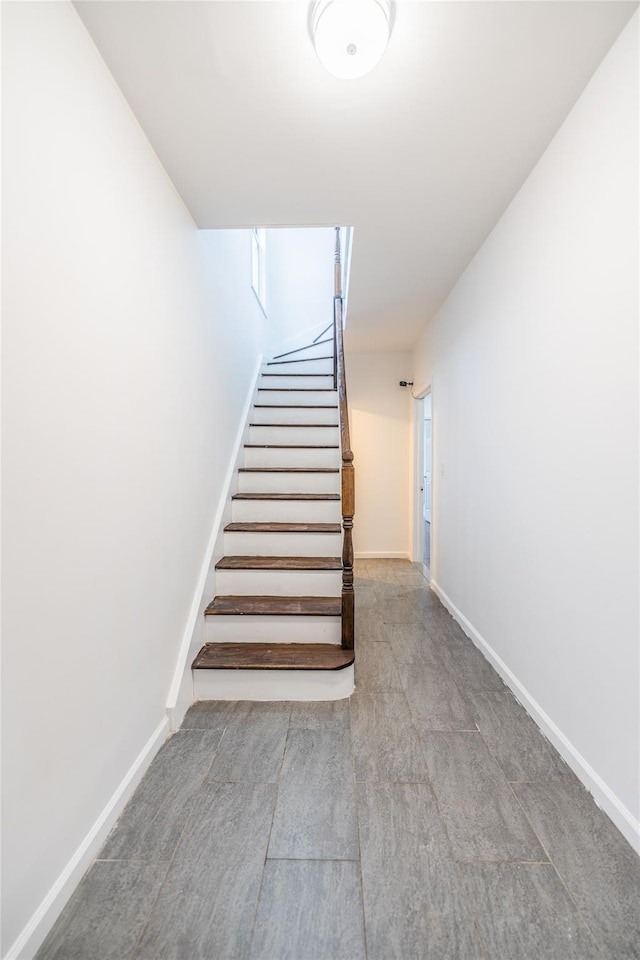 stairway featuring baseboards