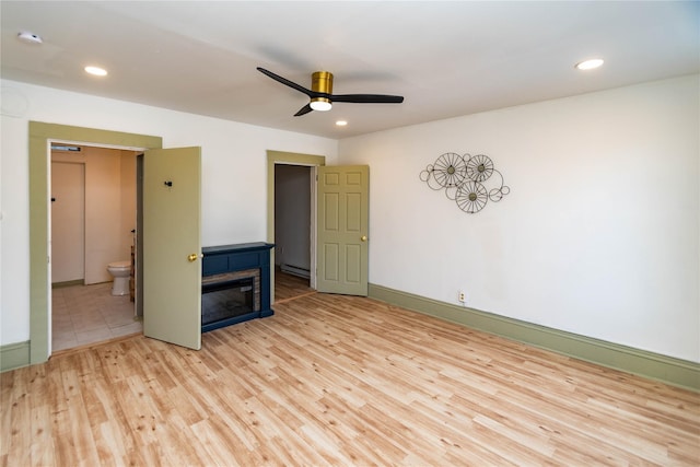 unfurnished room with light wood-style flooring, a fireplace, ceiling fan, and recessed lighting