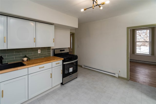 kitchen with white cabinetry, stainless steel range with gas cooktop, a baseboard heating unit, and a sink