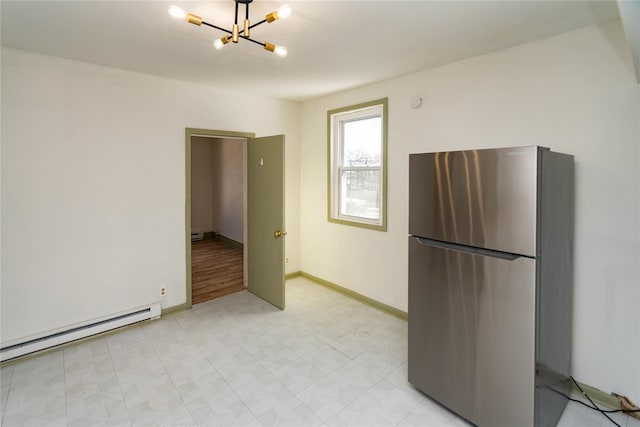 kitchen featuring baseboards, a baseboard radiator, freestanding refrigerator, light floors, and a chandelier