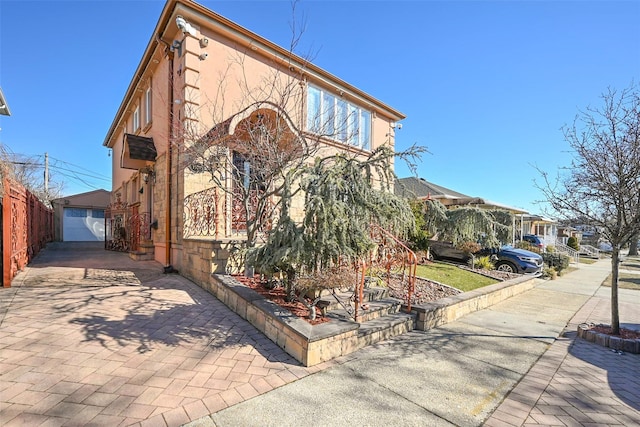 view of front of home featuring fence and stucco siding