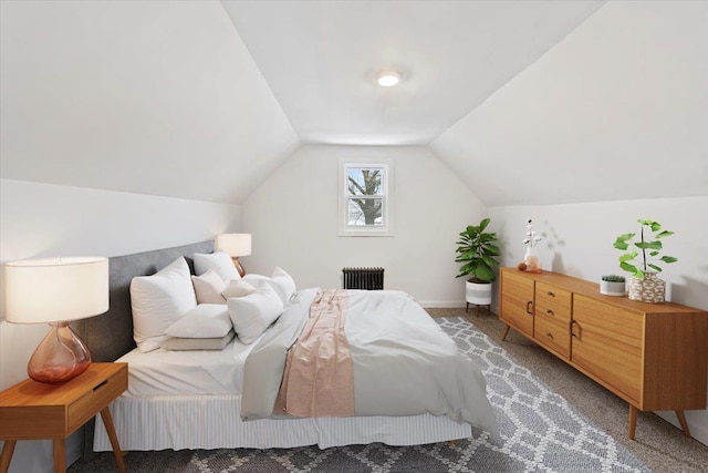 carpeted bedroom featuring vaulted ceiling and radiator heating unit