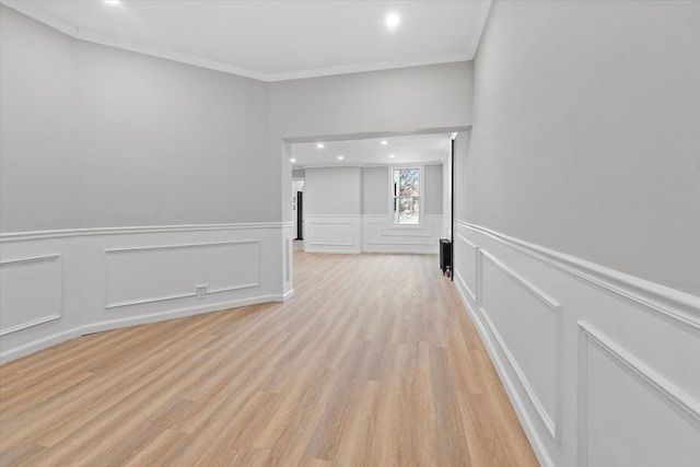 unfurnished room featuring light wood-type flooring, ornamental molding, and recessed lighting