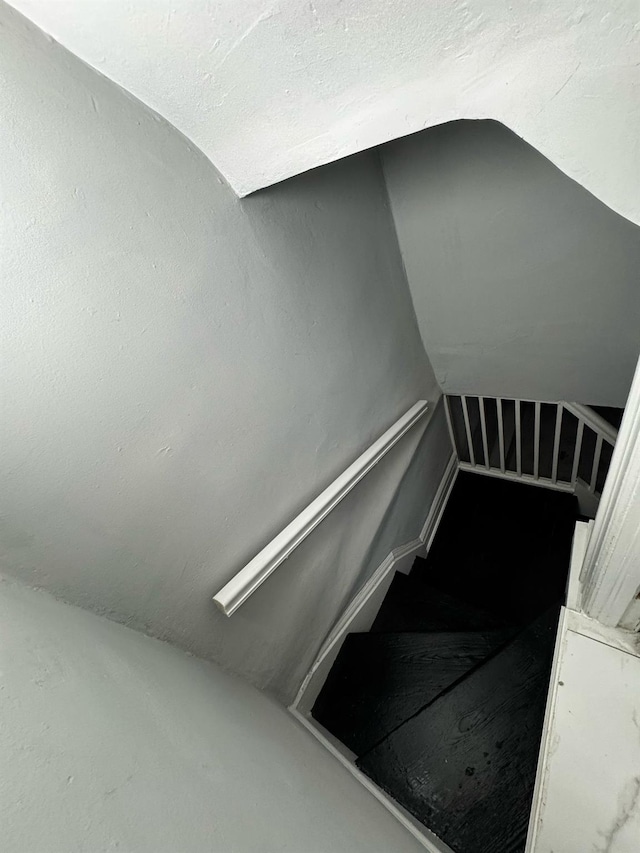 stairway featuring lofted ceiling