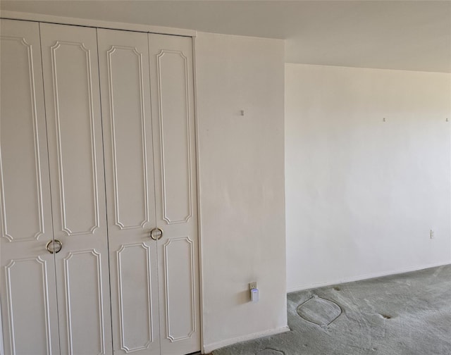 interior space with baseboards and carpet