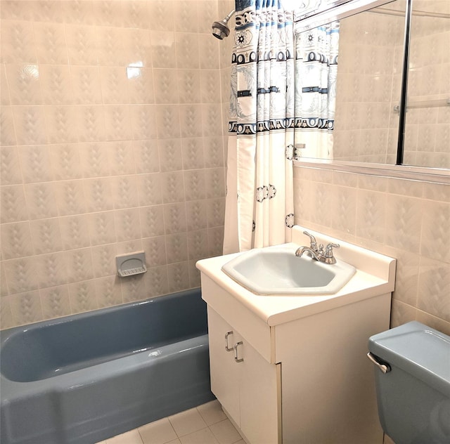 bathroom with vanity, tile patterned flooring, shower / tub combo, tile walls, and toilet