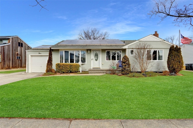 ranch-style house with a garage, solar panels, driveway, a chimney, and a front yard