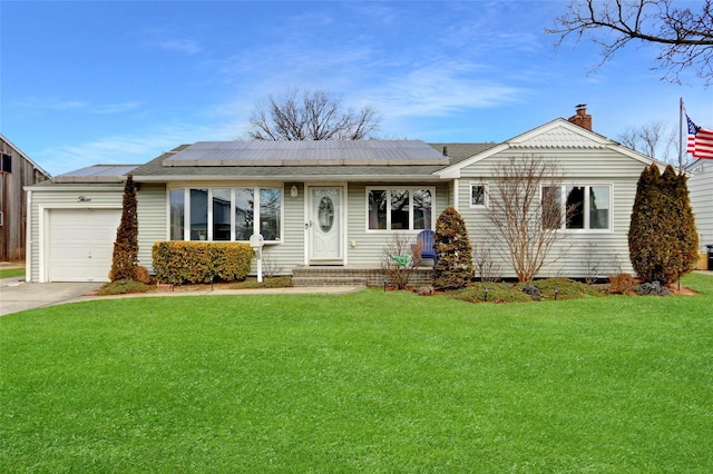 ranch-style house featuring a front yard, concrete driveway, an attached garage, and solar panels