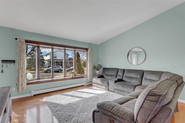 living room with baseboards, vaulted ceiling, baseboard heating, and wood finished floors